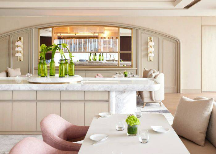 The bright, modern interiors of Sezanne, featuring marble-topped counters and fresh flowers.