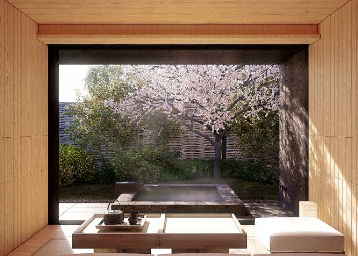 An elegant sitting area at Amanemu, next to a private hot spring bath and a blossoming sakura tree.