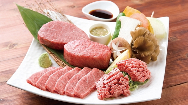 Elegant display of premium cuts of raw beef with garnish