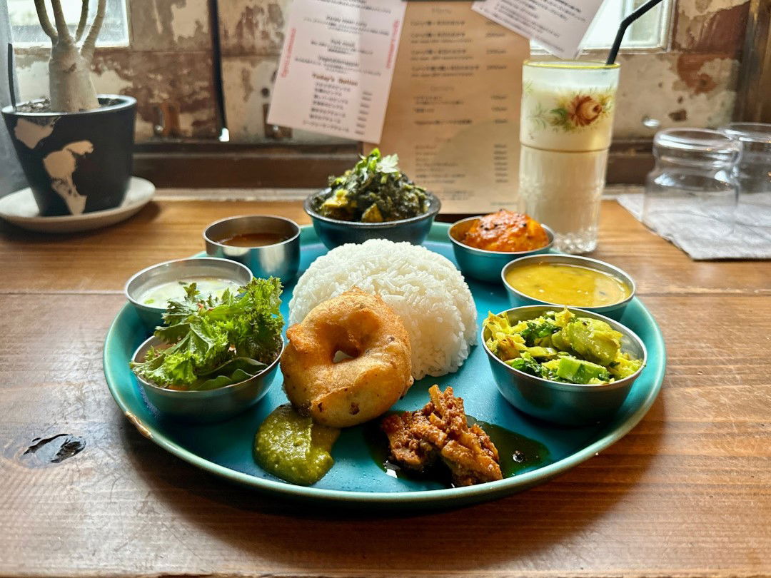 A platter of dishes at Toi Inshokuten, featuring salad, tempura, rice and a selection of small dishes.