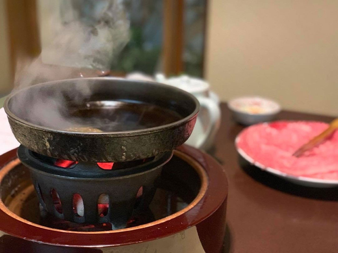 Traditional hot pot cooking with steaming broth