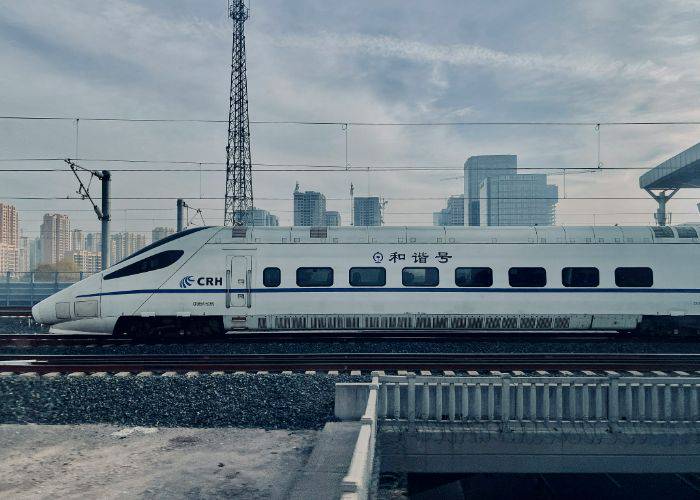 The shinkansen bullet train zooming along the tracks.