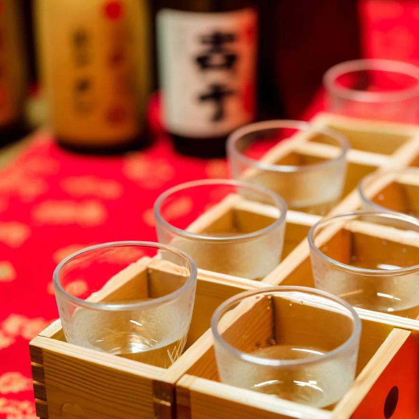 A selection of sake cups lined up at a sake tasting tour.