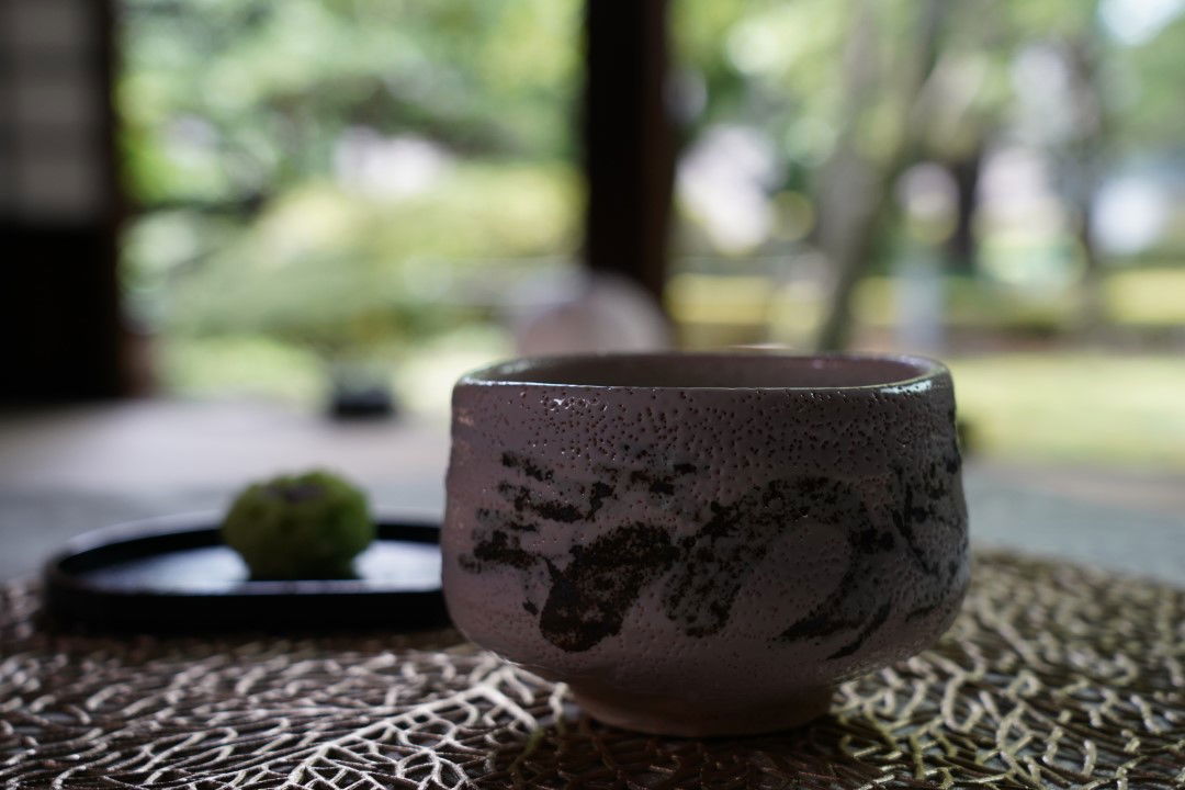 A cup of Japanese tea and a wagashi sweet, served on our Tokyo National Museum dining and matcha experience.