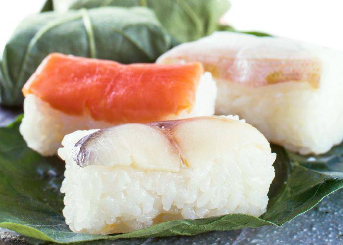 Kakinohazushi, a type of sushi that is pickled and wrapped in a persimmon leaf.