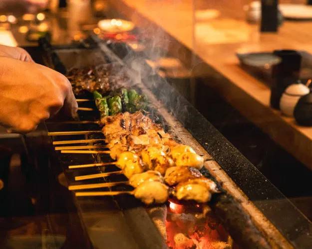 A selection of yakitori skewers on the grill.