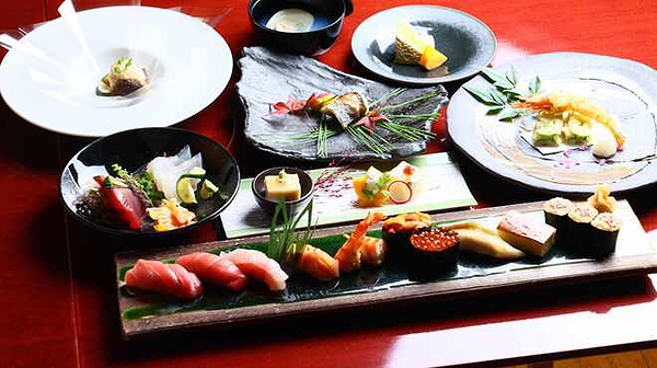 Elegant sushi and sashimi platter with assorted side dishes