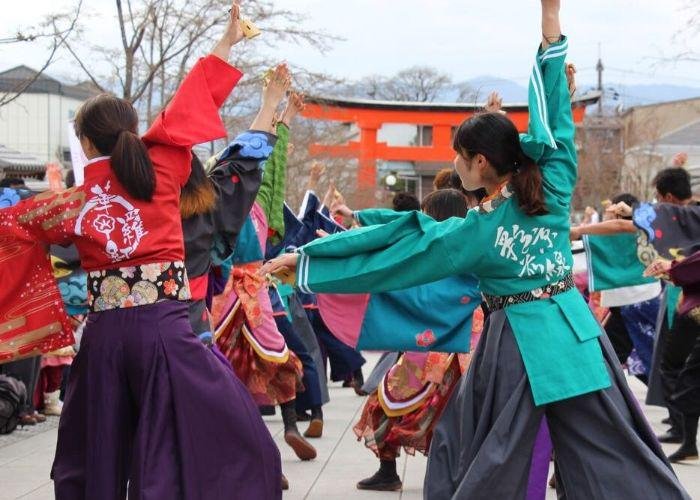 Students in colorful Japanese traditional dress dance during the  Kyoto Intercollegiate Festival outside