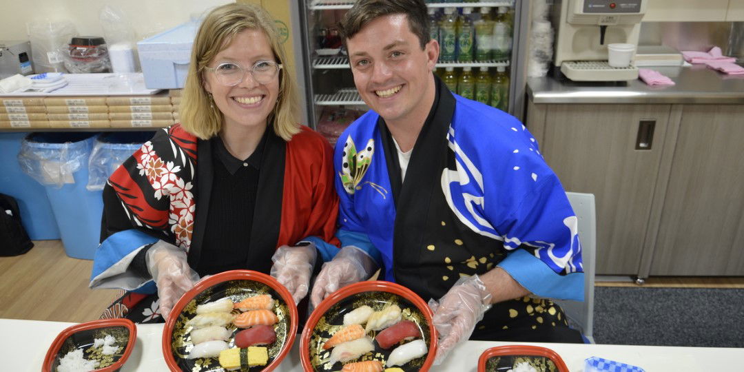 Two guests of the Daiki Suisan Sushi Seminar Dotonbori, proud of their handmade sushi.