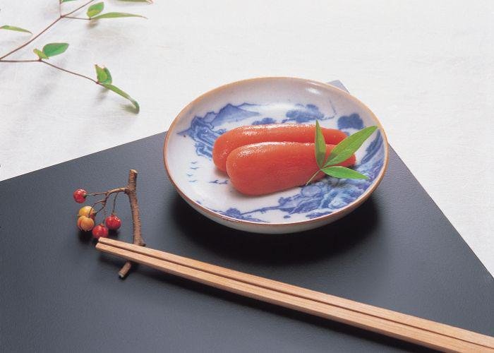 Dark pink mentaiko, fish egg, clusters plated elegantly on blue and white porcelain