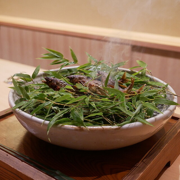 Steaming dish with greens at upscale restaurant