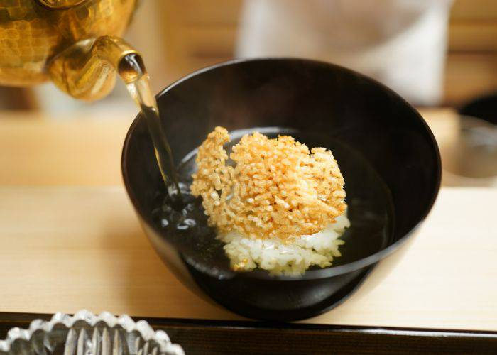 Tea being poured into a traditional ochazuke dish at Kataori.