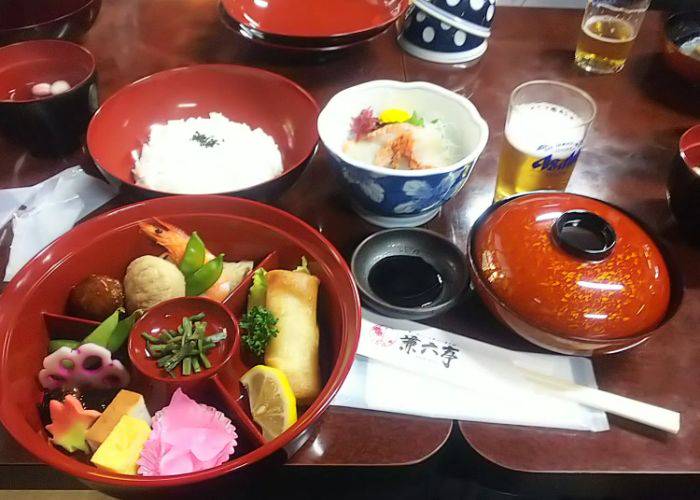 A delicious kaiseki multicourse meal at Kenrokutei, served in the traditional red lacquerware.