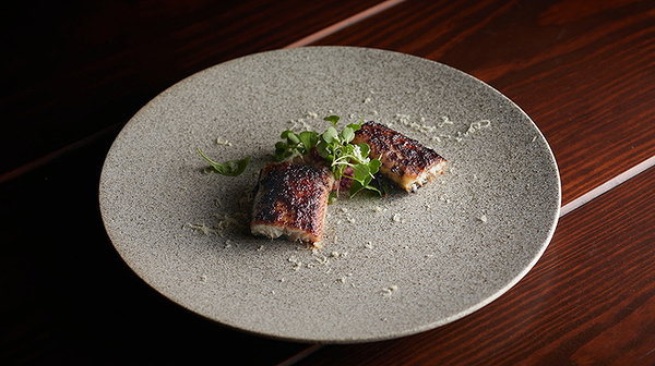 Gourmet grilled fish with fresh herbs on a stylish ceramic plate