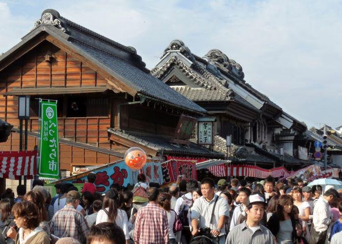 Crowds of people along the ancient street, with buildings from the Edo period, during the Kawagoe Matsuri