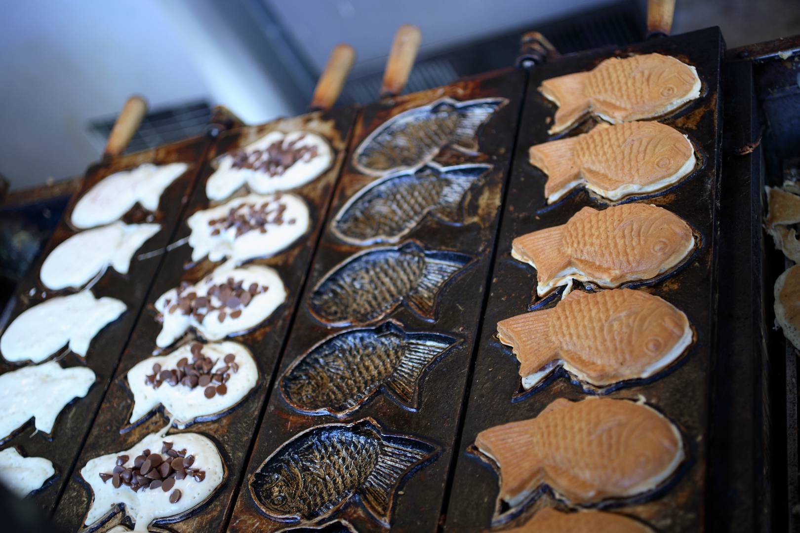 Taiyaki being cooked in the classic fish-shaped mold.