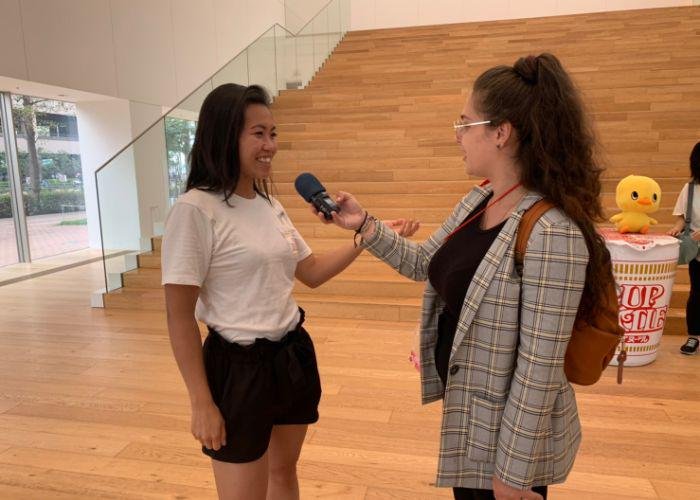 Tabesugi podcast host Emilie Lauer interviews a woman at the Cup Noodles Museum