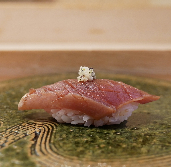 Exquisite sushi piece on elegant ceramic plate