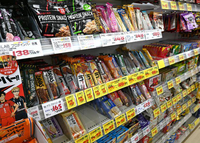 A selection of Japanese protein bars and snacks at a supermarket.