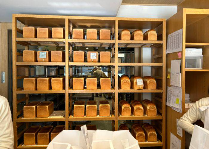 The shelves at Centre the Bakery, filled with fresh shokupan loaves.