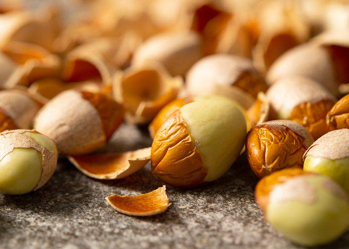 A close-up of ginkgo nuts, some of which are peeled.