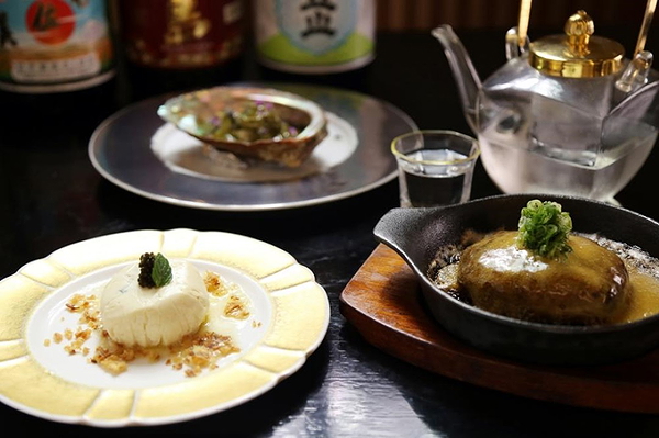 Exquisite gourmet dishes and tea set at a fine dining restaurant