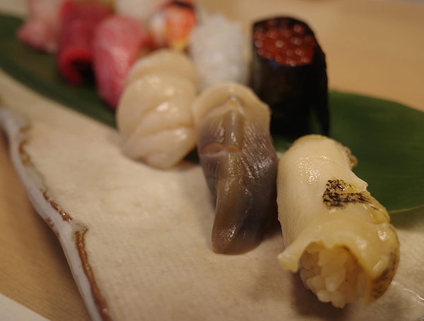 Assorted sushi platter with fresh seafood on a banana leaf