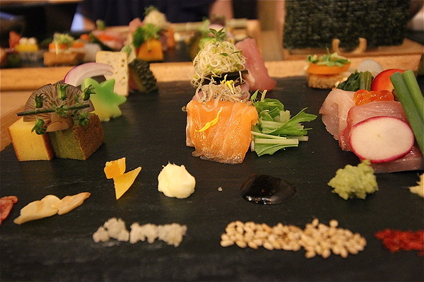 Gourmet sushi platter with assorted fresh toppings and garnishes