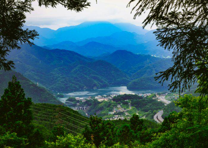 The views from the summit of Mt. Takao, showing off lakes, mountains and lush nature.