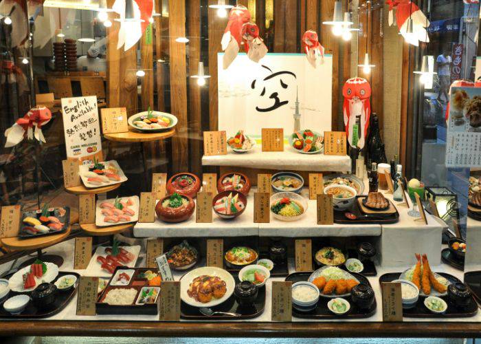 A Japanese fake food display in front of a restaurant.