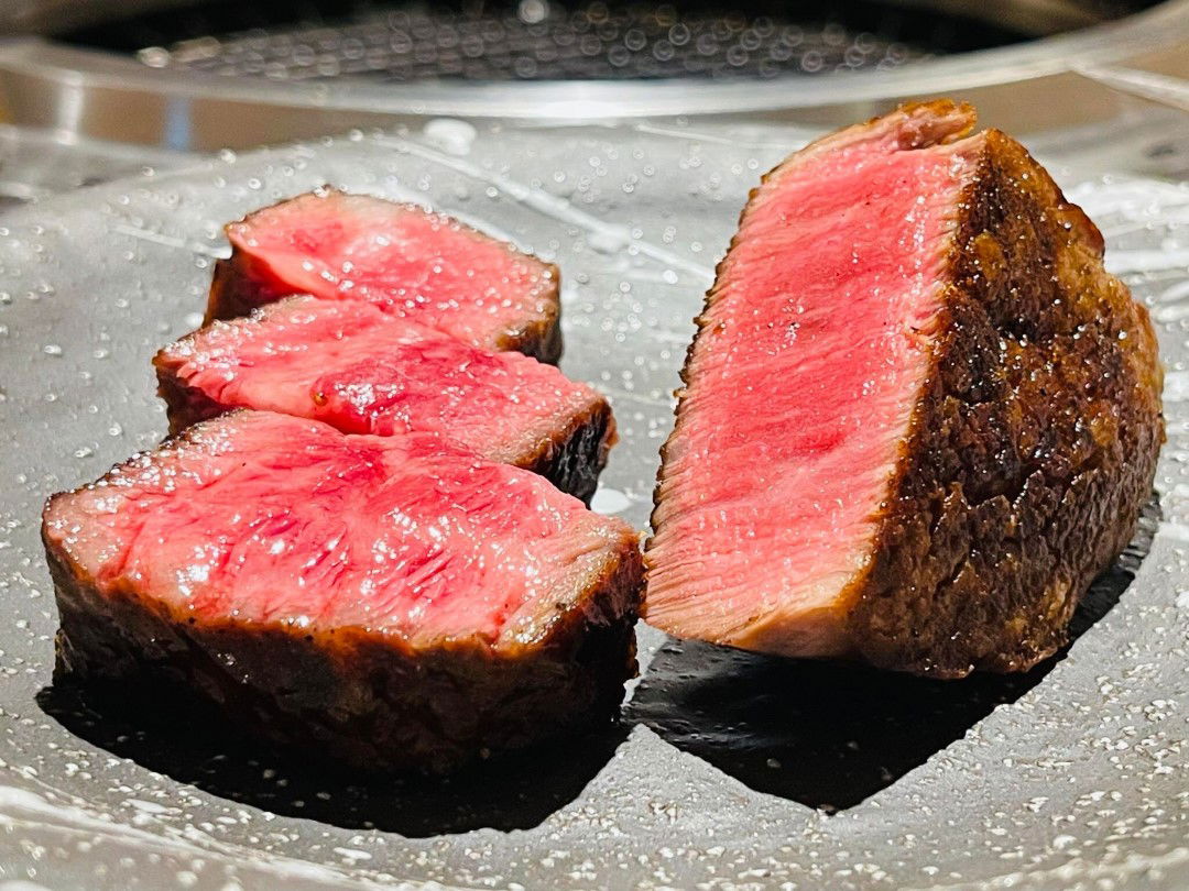 Premium cuts of wagyu beef at Wagyu Yakiniku Kakunoshin Roppongi, finely marbled and still pink in the center.