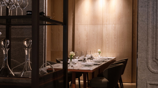 A warmly lit dining area at Dominique Bouchet Tokyo.