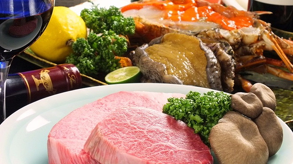 Gourmet steak and seafood platter with wine