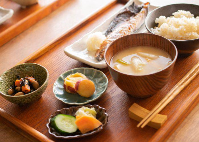 Japanese teishoku meal: Fish, rice, a bowl of miso soup, side dishes and pickles.