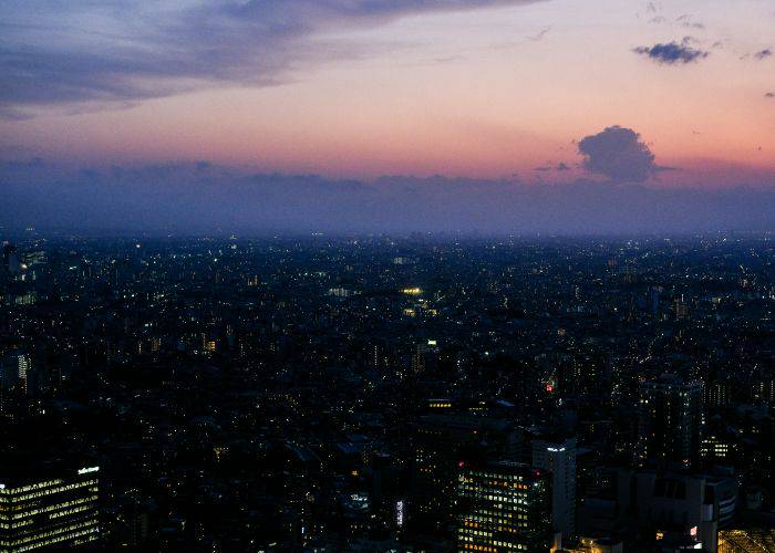 The Ikebukuro skyline as the sun sets; the lights glow in the darkness.