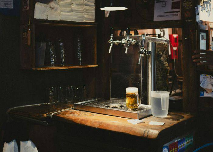 A freshly poured glass of beer behind the bar of an izakaya in Japan.