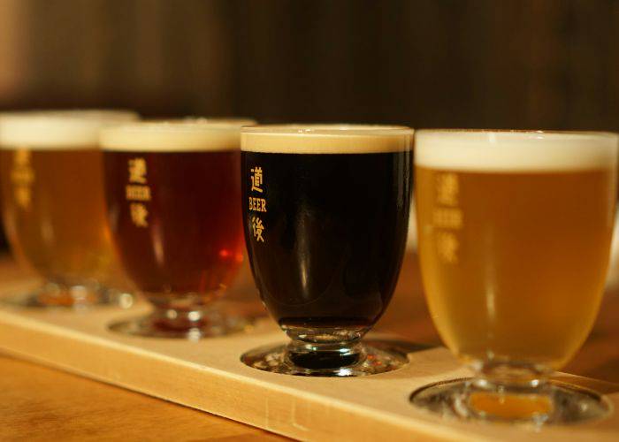 A beer tasting board in Japan, featuring a pale ale, amber ale and stout.