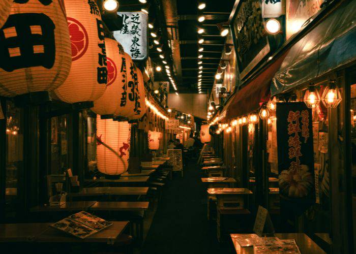 A traditional paper lantern lighting a drinking alley in Japan.