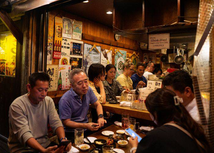 People in Japan enjoying an evening of drinking in a Japanese drinking alley.