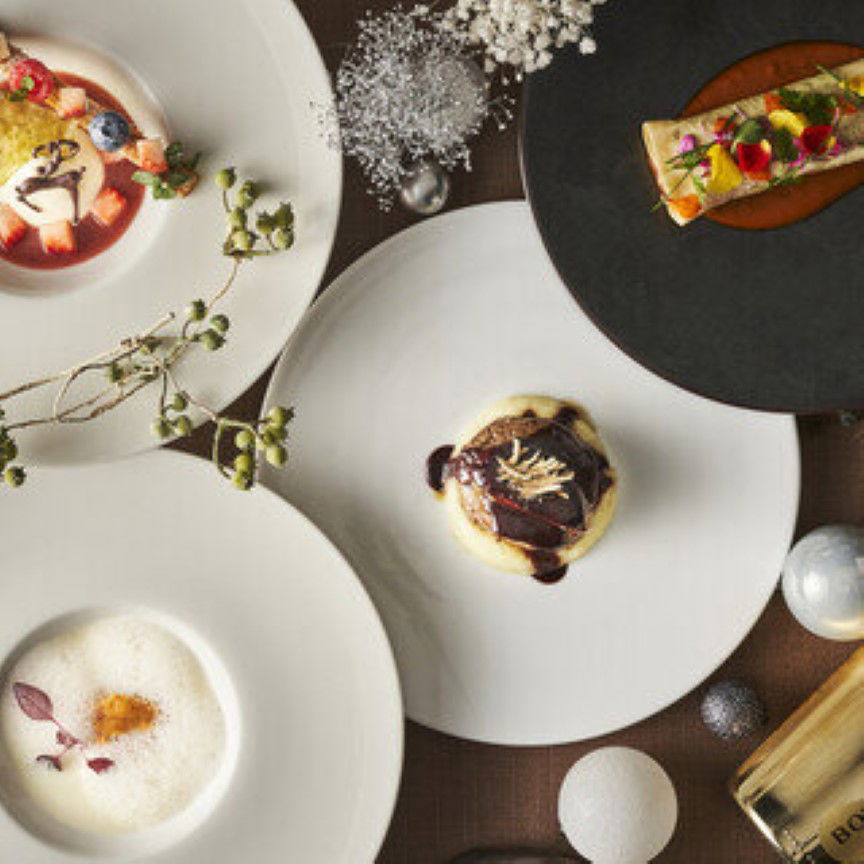 Elegant gourmet course meal with diverse plated dishes