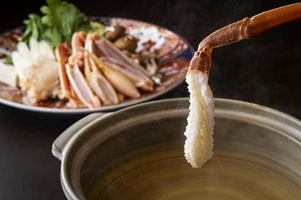 Japanese hot pot with fresh vegetables and seafood in a steaming broth