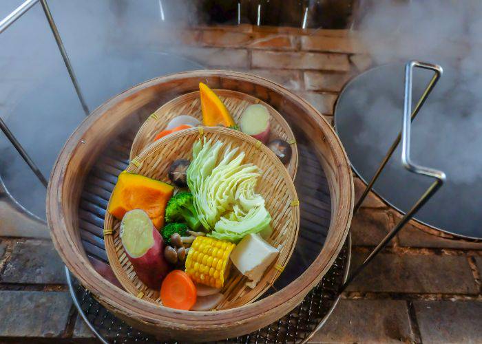 Fresh vegetables in a basket, waiting to be steamed by the steam from Beppu's onsen.