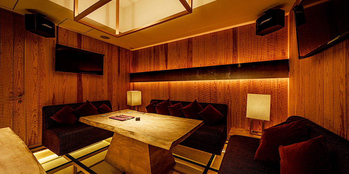 A luxurious private room with three couches surrounding a table at Sushi Yon in Tokyo