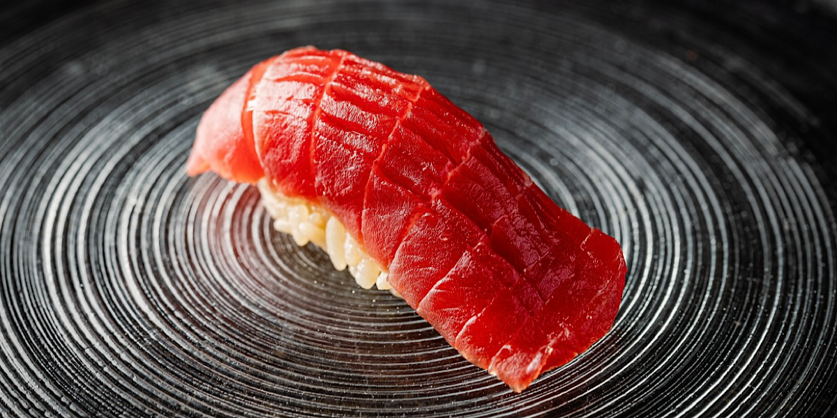 A fresh cut of fish laid over vinegared rice to perfect sensational sushi.