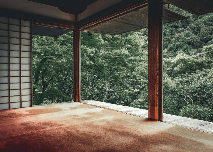 A minimalist temple in Kyoto, looking out into greenery.