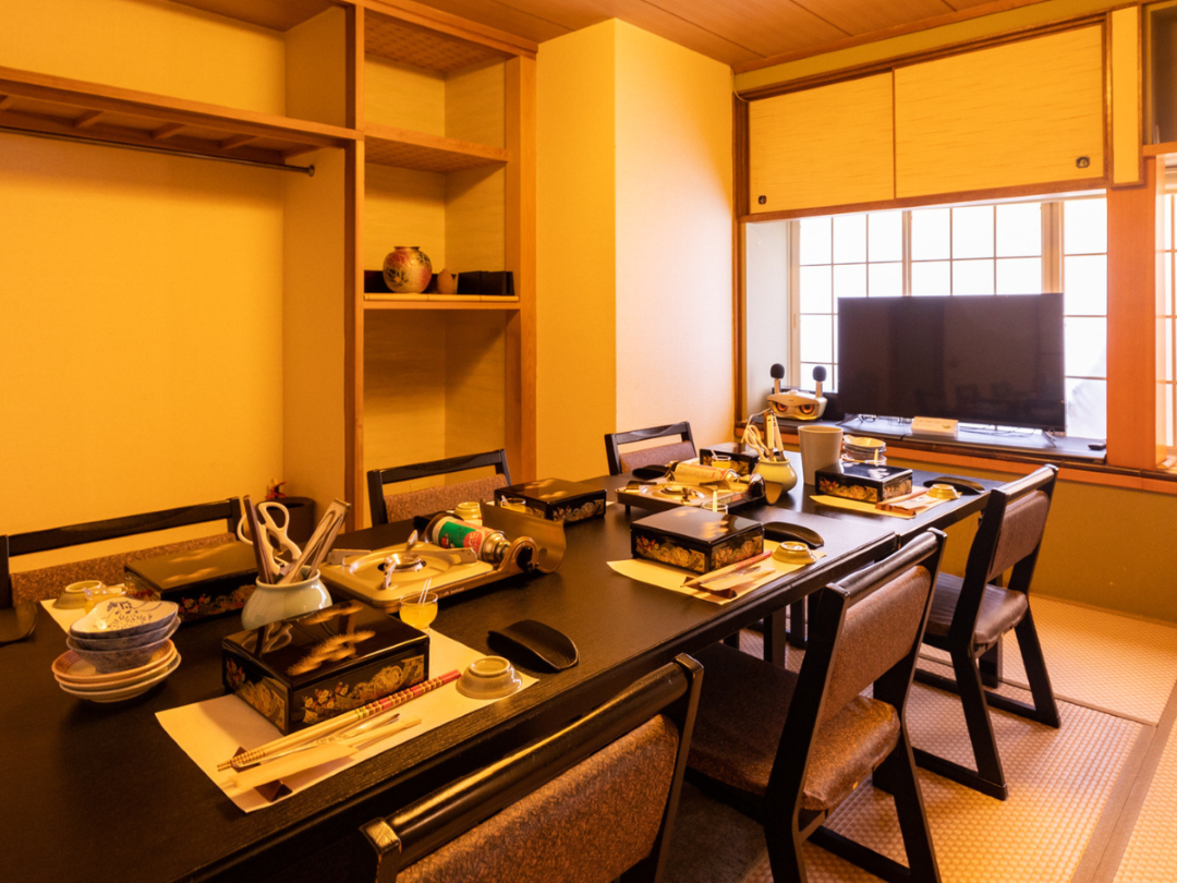 The warm dining area of Wagyu Kappo Toraichi, laid for dinner.