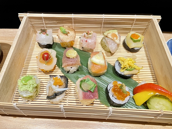 Assorted sushi platter on a bamboo tray with vibrant toppings