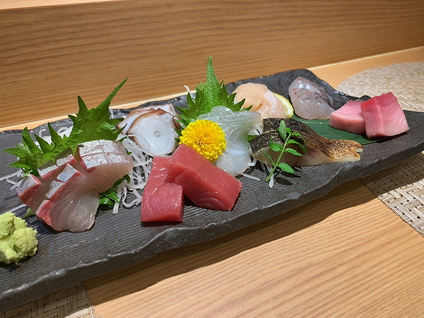 Assorted fresh sashimi platter on a slate serving board