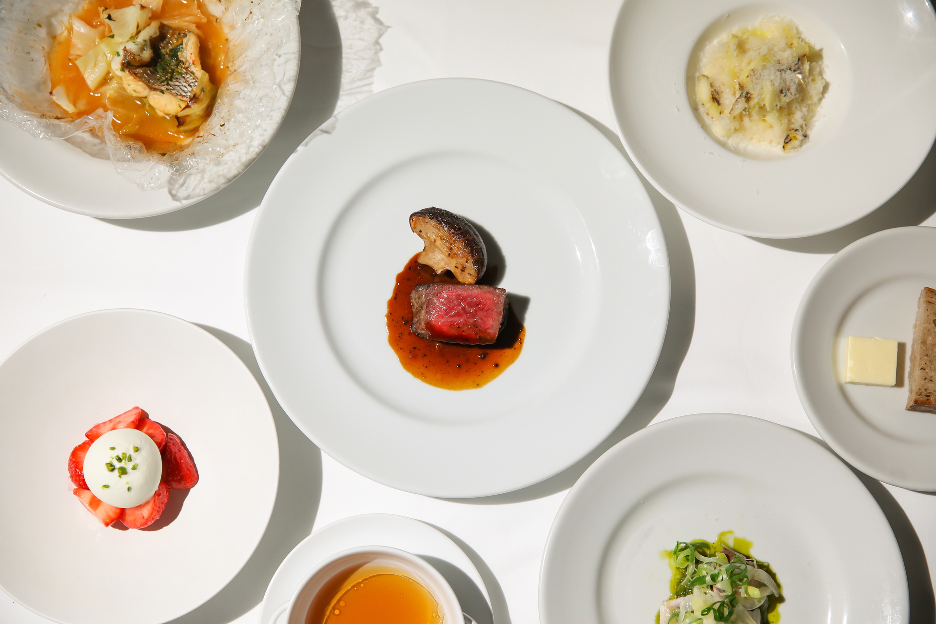 Gourmet course menu with steak, seafood, and dessert