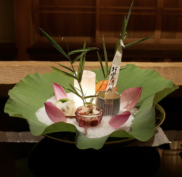 Elegant sushi platter with lotus leaves and decorative elements